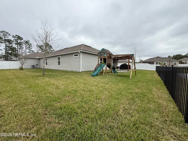 a view of a house with a yard and sitting area