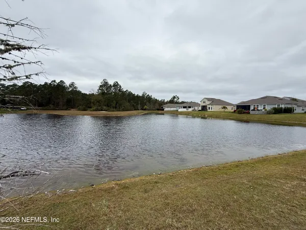 a view of a lake with houses in the back