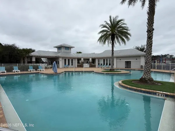 a front view of house with yard and lake view