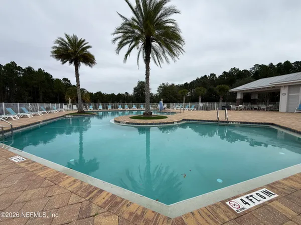 a view of a swimming pool with a table and chairs