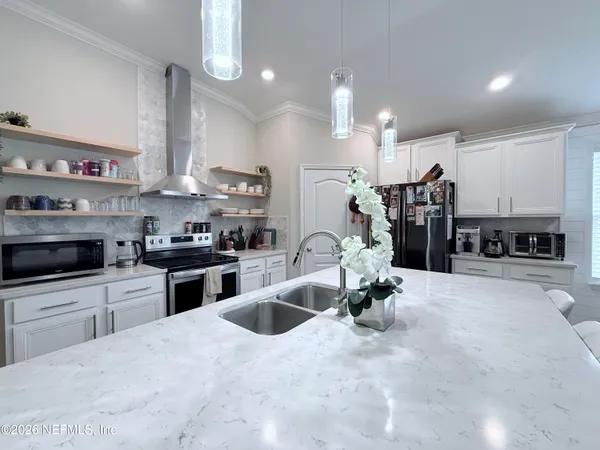 a kitchen with stainless steel appliances kitchen island granite countertop a sink and cabinets
