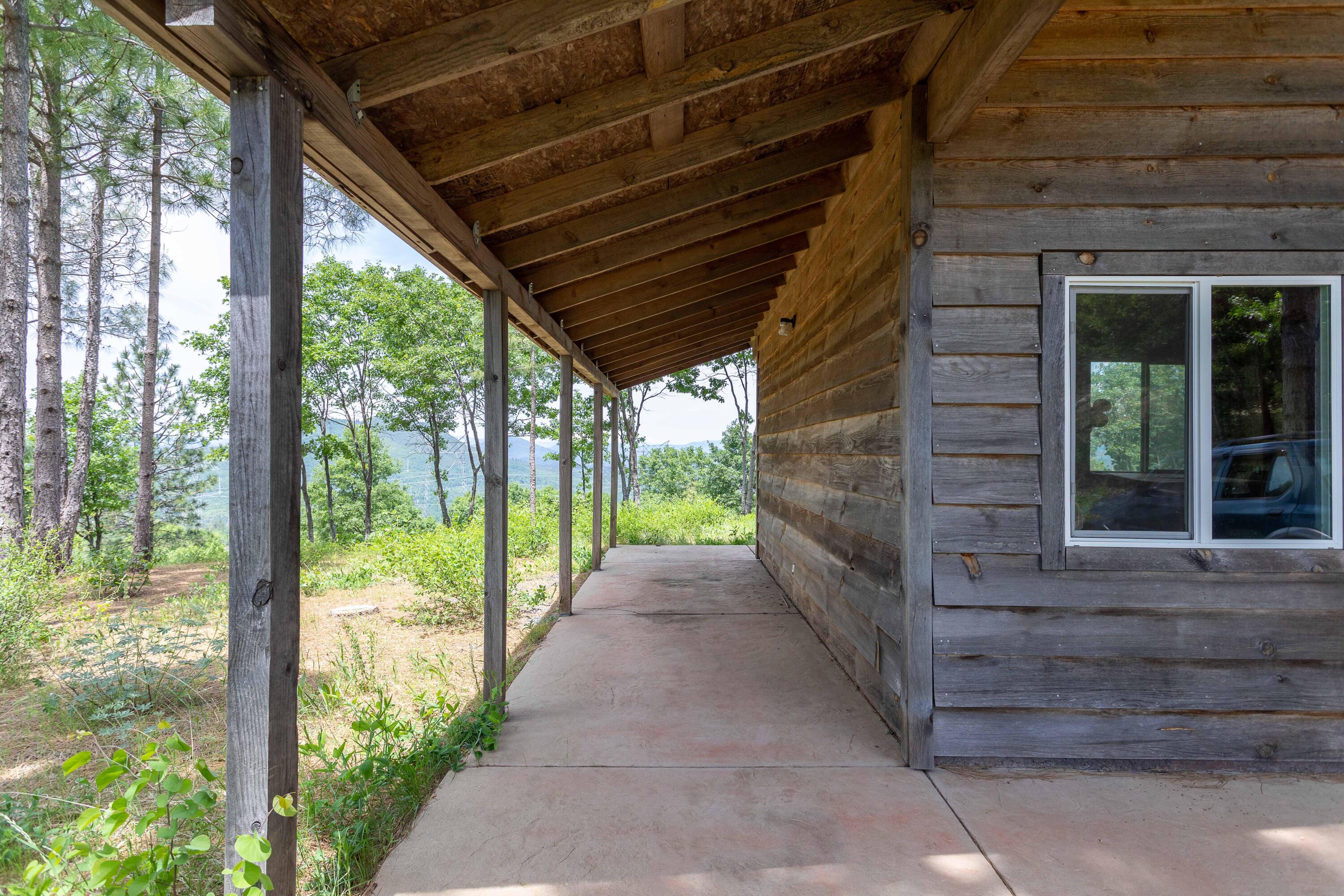320 Acres Melton Road Bella Vista, CA 96008 - Photo 2 of 19 a view of a pathway of a house with a large window