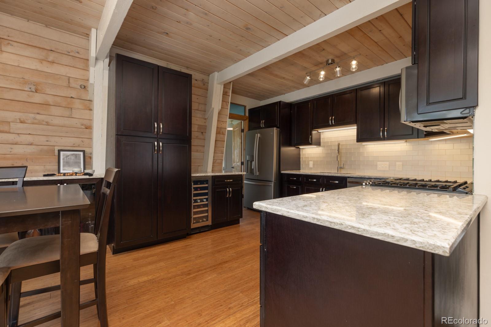 213 Big Elk Road Dillon, CO 80435 - Photo 11 of 50 a kitchen with kitchen island a counter top space cabinets and stainless steel appliances