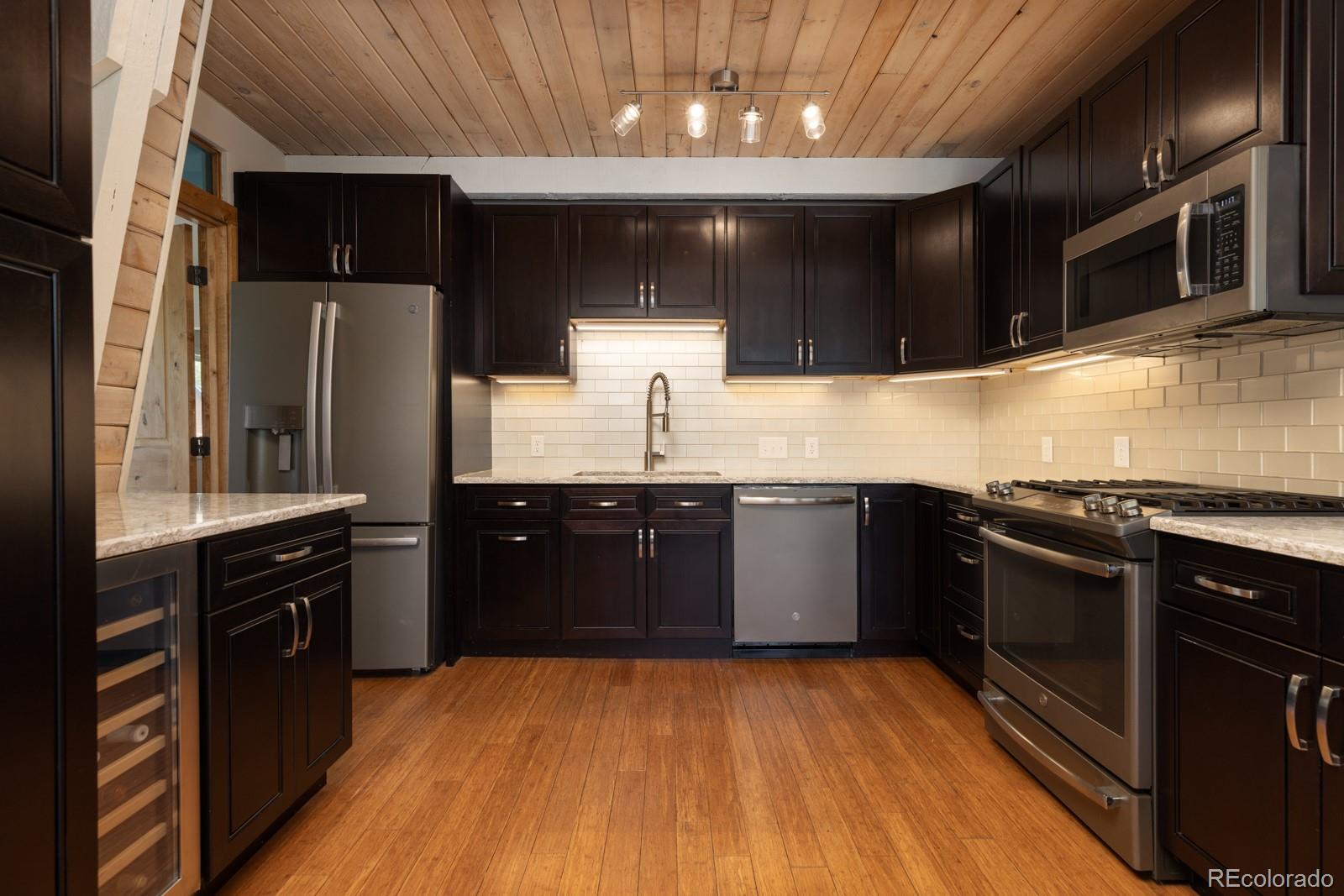 213 Big Elk Road Dillon, CO 80435 - Photo 12 of 50 a kitchen with stainless steel appliances granite countertop a stove a sink and a microwave