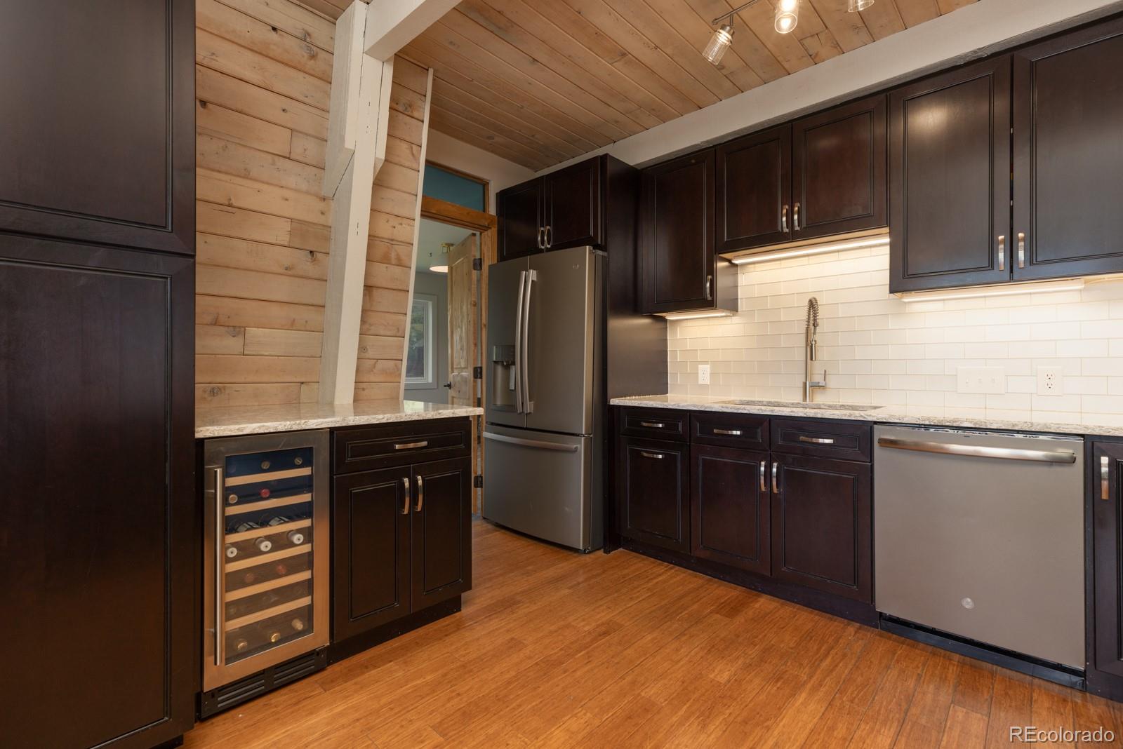 213 Big Elk Road Dillon, CO 80435 - Photo 13 of 50 a kitchen with stainless steel appliances granite countertop a refrigerator and a stove top oven