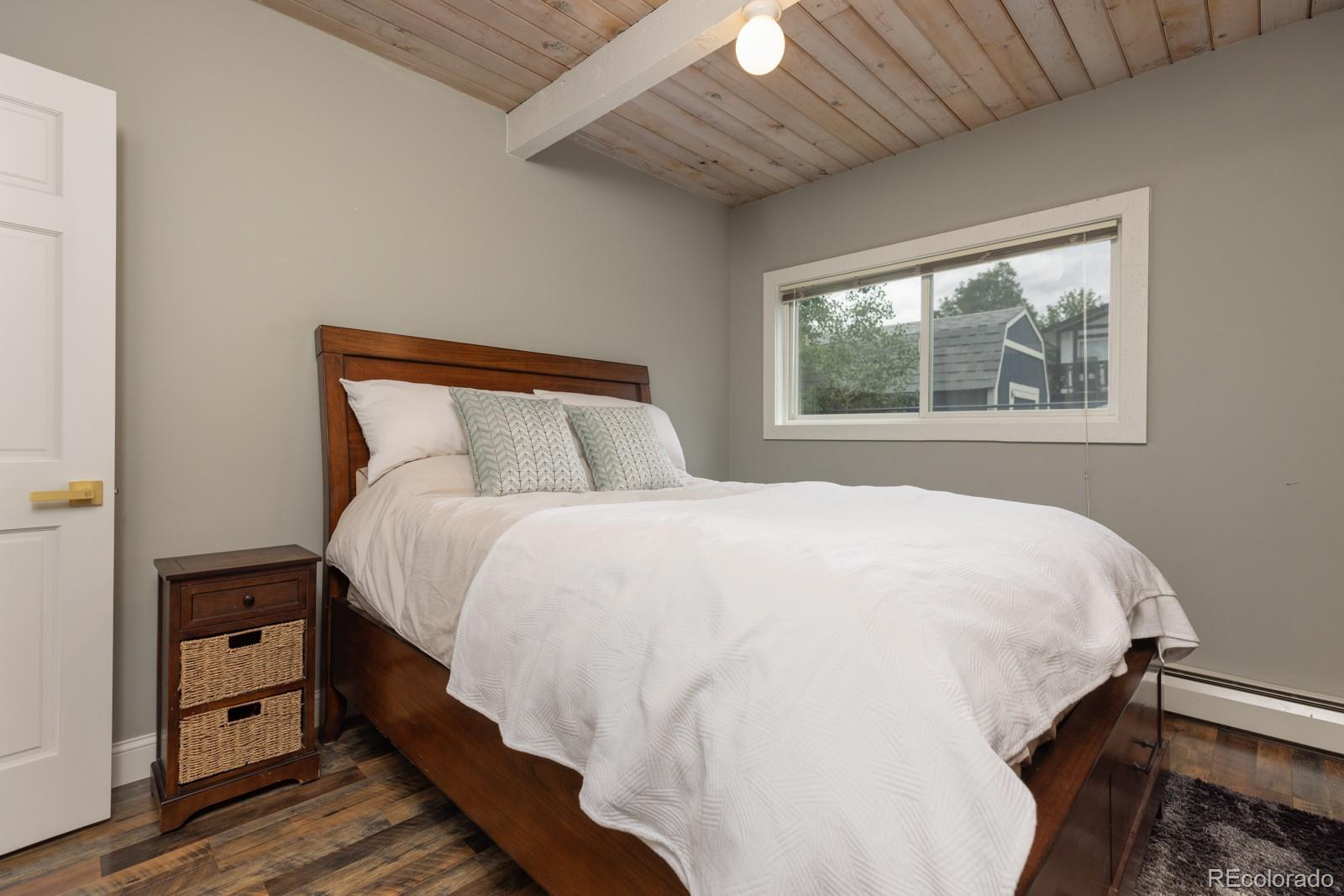 213 Big Elk Road Dillon, CO 80435 - Photo 22 of 50 a large bed sitting in a bedroom next to a window