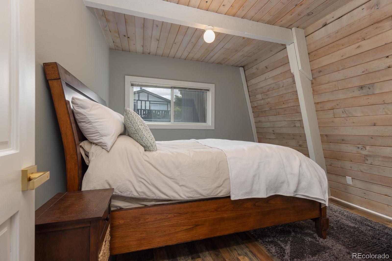213 Big Elk Road Dillon, CO 80435 - Photo 23 of 50 a bed sitting in a bedroom next to a window