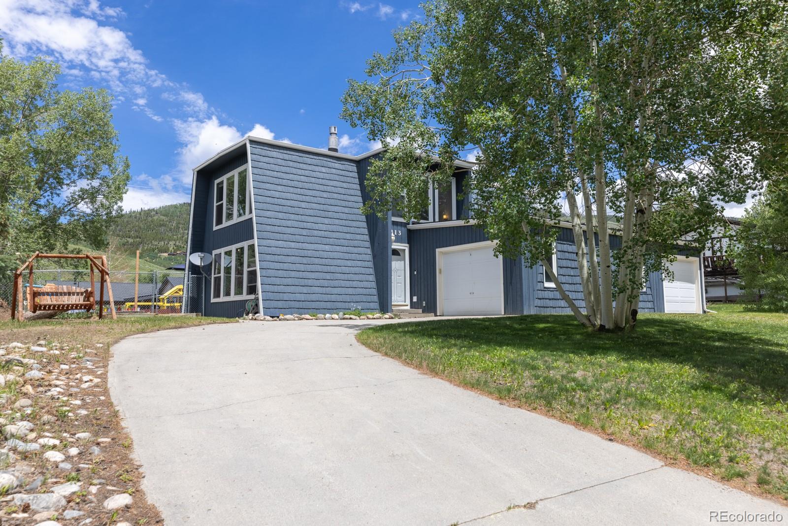 213 Big Elk Road Dillon, CO 80435 - Photo 3 of 50 a front view of a house with a yard and a garage