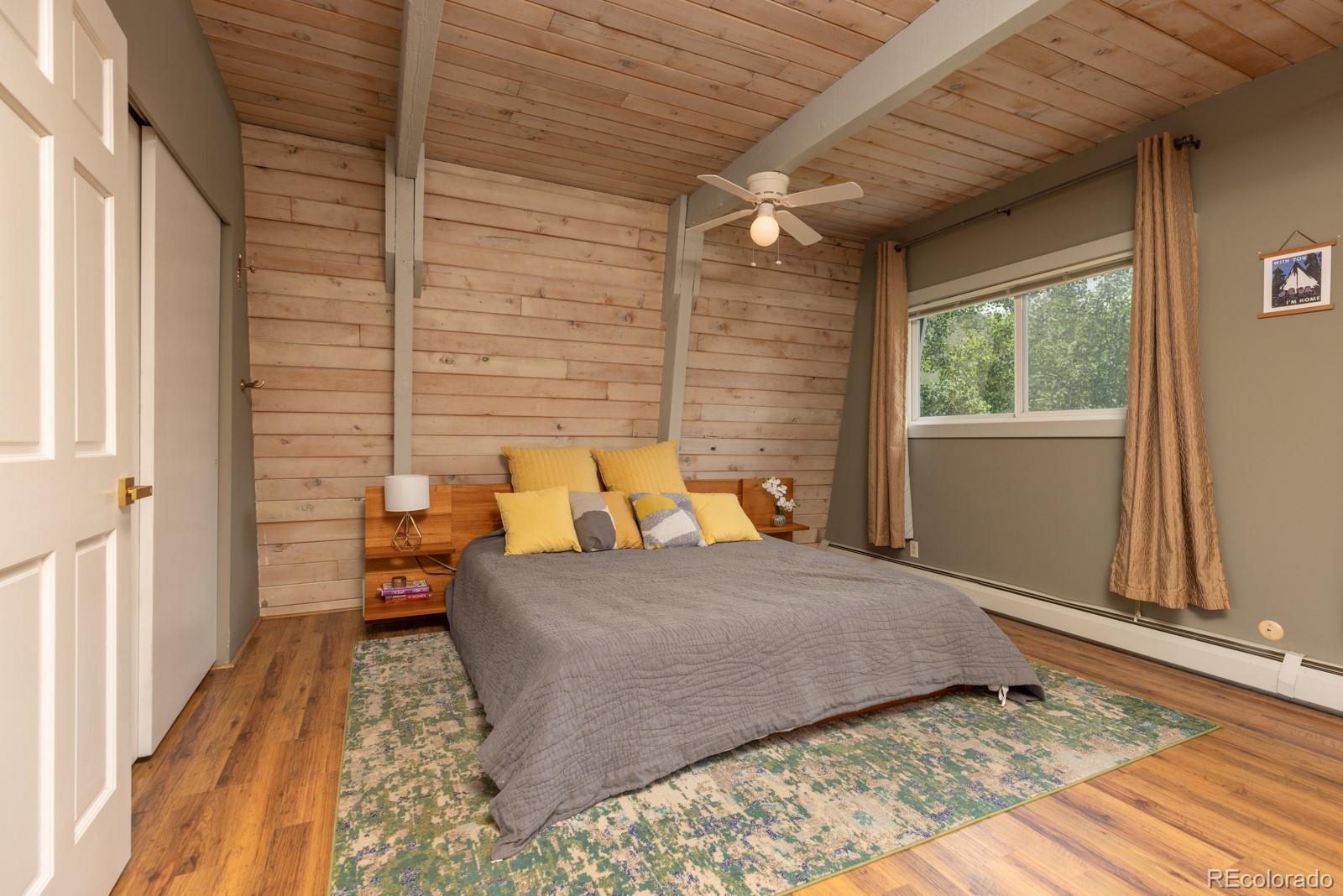 213 Big Elk Road Dillon, CO 80435 - Photo 37 of 50 a bedroom with a bed and wooden floor