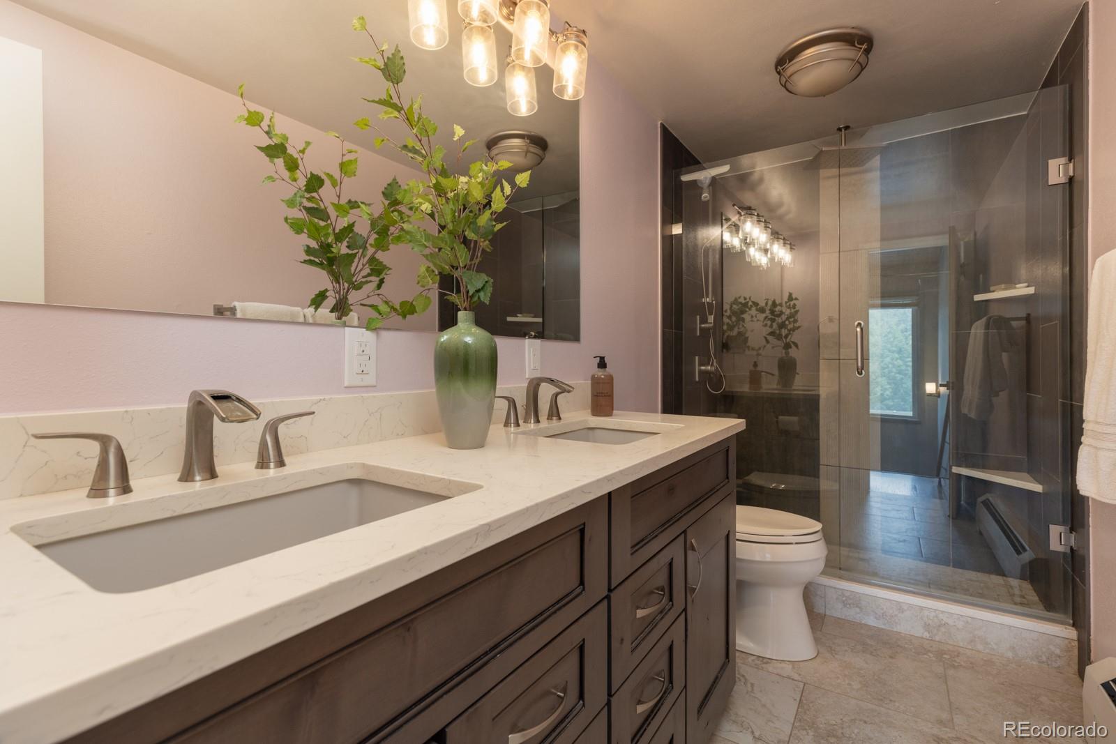 213 Big Elk Road Dillon, CO 80435 - Photo 42 of 50 a bathroom with a granite countertop sink and a mirror