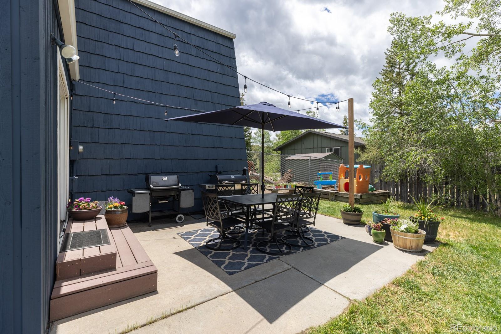 213 Big Elk Road Dillon, CO 80435 - Photo 48 of 50 a view of a patio with table and chairs and potted plants
