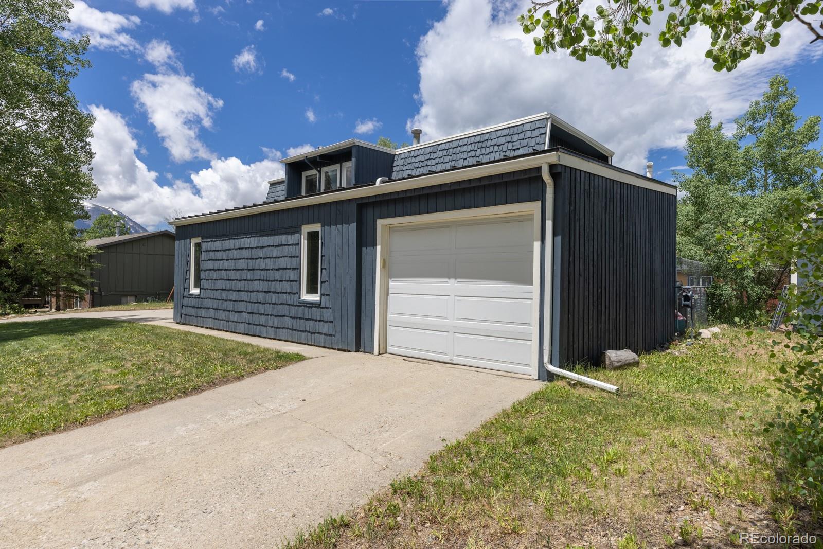 213 Big Elk Road Dillon, CO 80435 - Photo 50 of 50 a front view of a house with a yard and garage