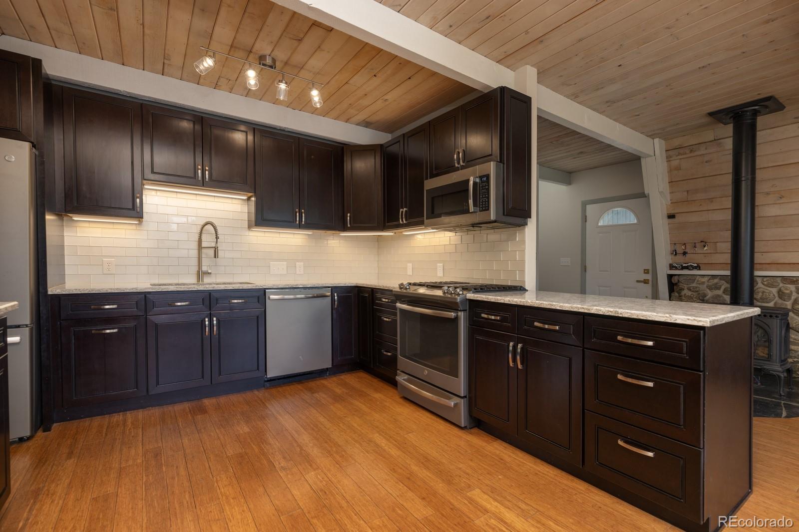 213 Big Elk Road Dillon, CO 80435 - Photo 6 of 50 a kitchen with stainless steel appliances granite countertop a sink counter space and cabinets