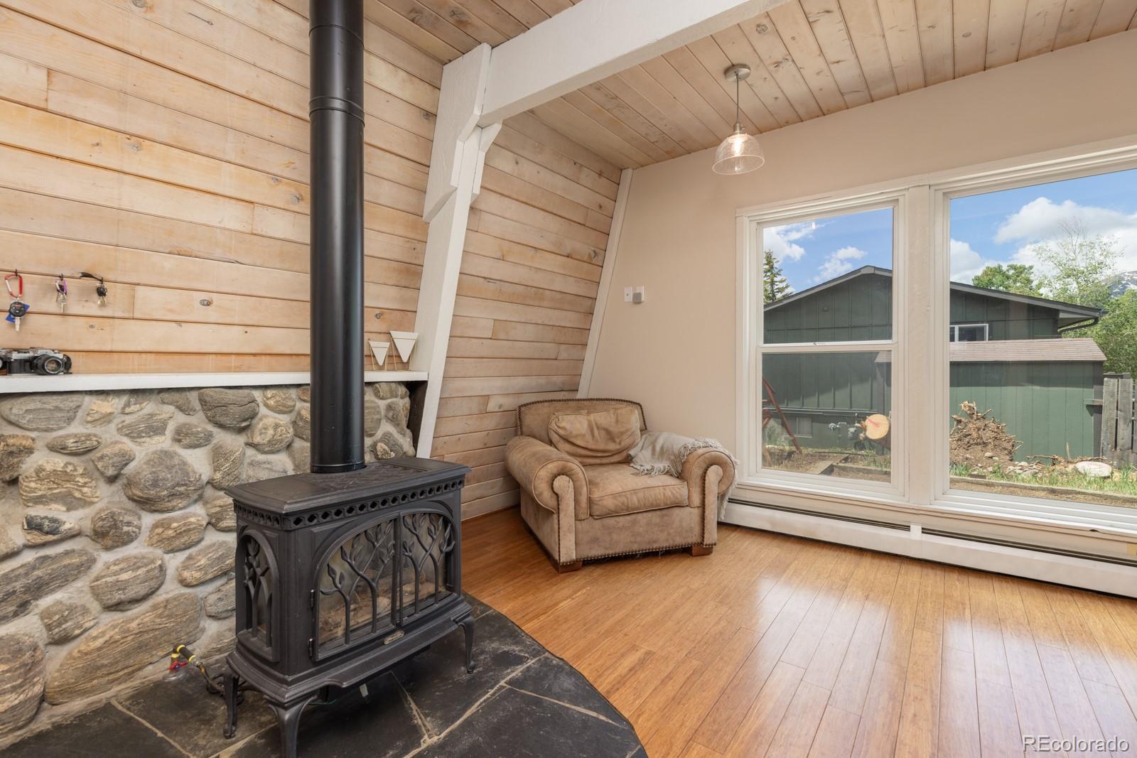 213 Big Elk Road Dillon, CO 80435 - Photo 7 of 50 a living room with furniture and a floor to ceiling window