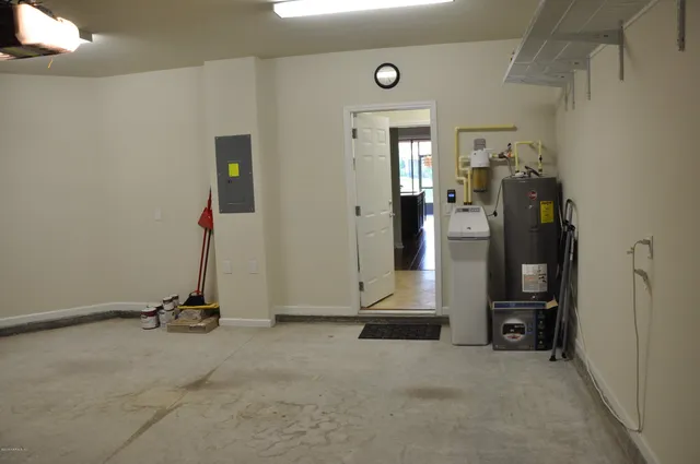 a view of a hallway with a view of gym equipment