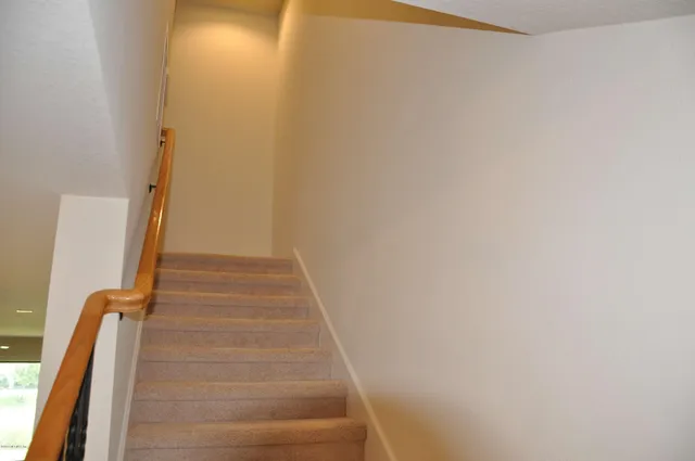 a view of staircase with white walls