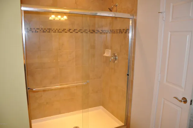 a bathroom with a glass shower door