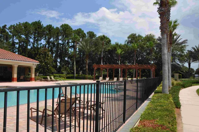 a view of a house with backyard and trees
