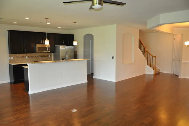 a view of kitchen with furniture and wooden floor