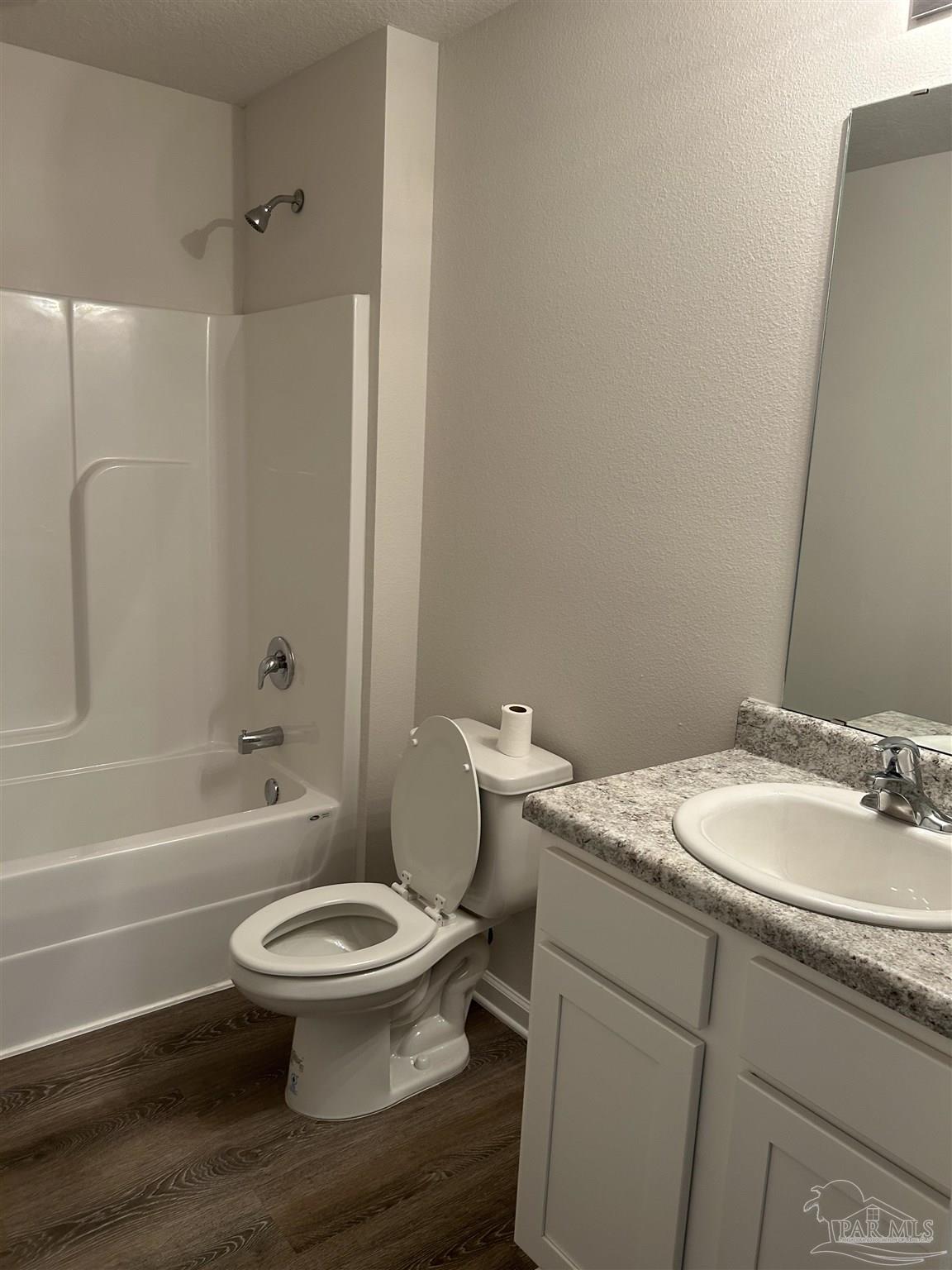 5351 Peach Drive Pace, FL 32571 - Photo 15 of 24 a bathroom with a granite countertop toilet a sink and a bathtub