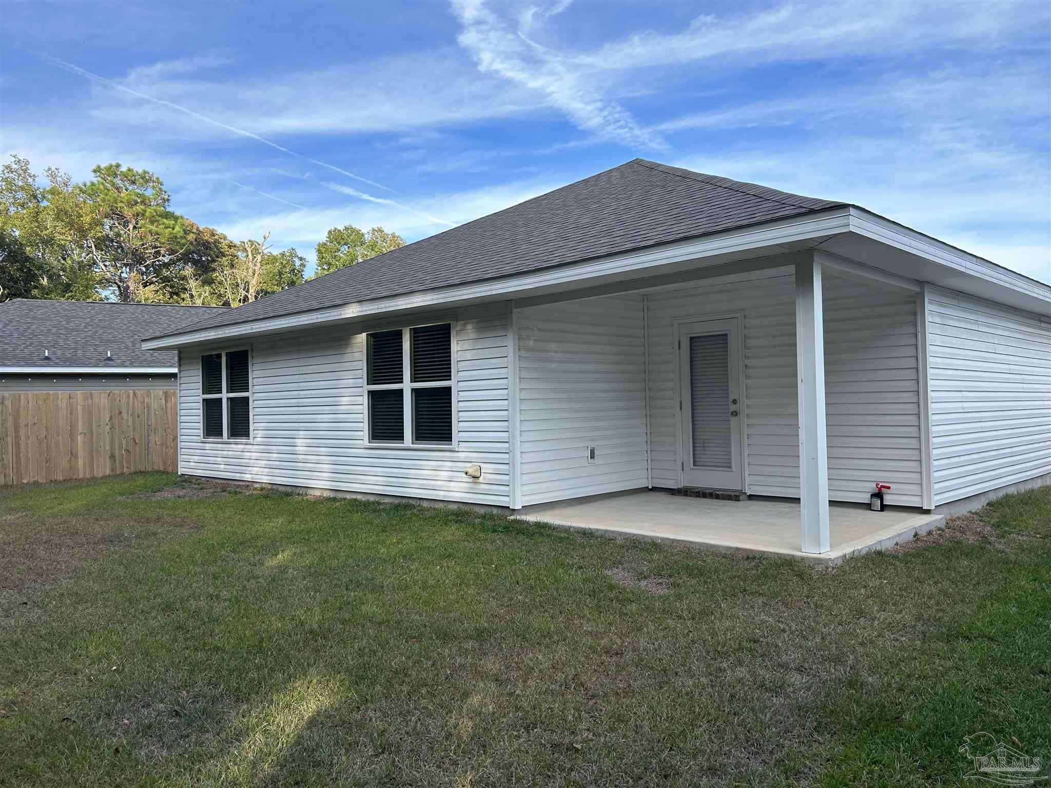 5351 Peach Drive Pace, FL 32571 - Photo 17 of 24 a backyard of a house with lots of green space