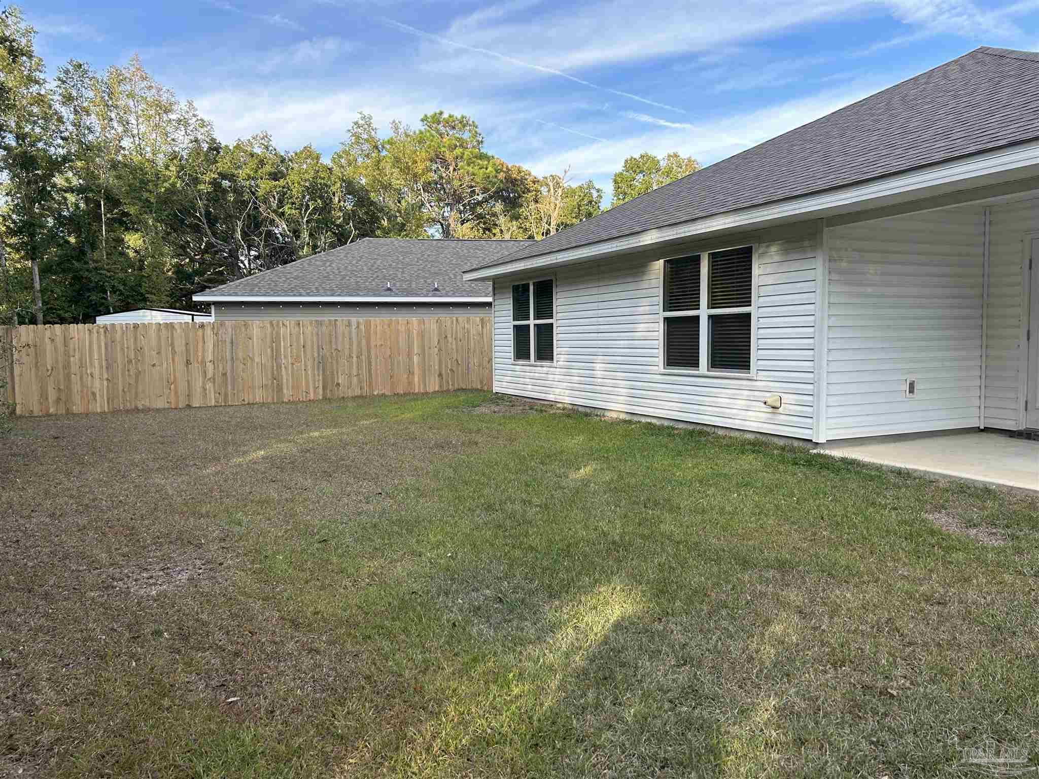 5351 Peach Drive Pace, FL 32571 - Photo 18 of 24 a view of a backyard