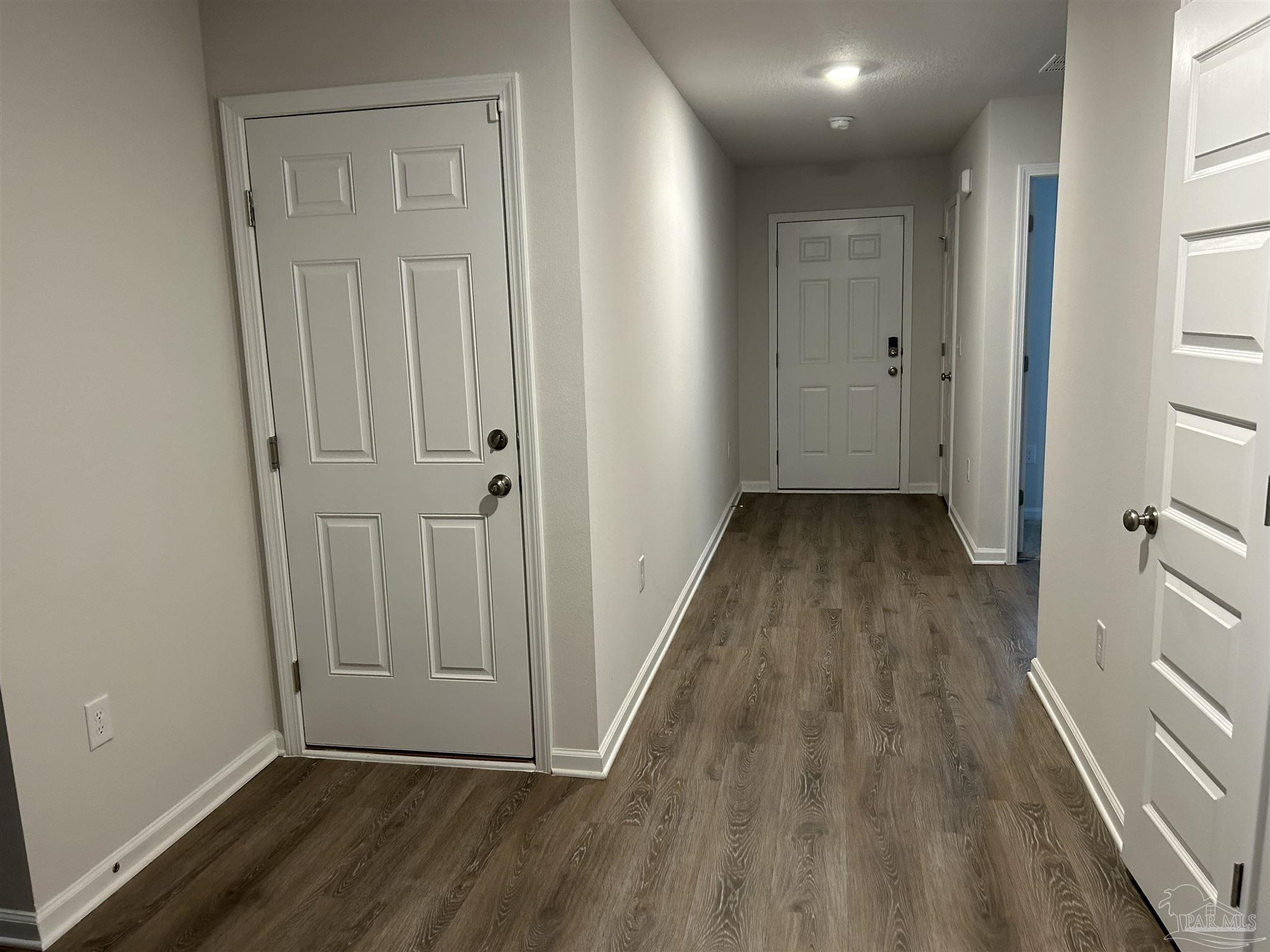 5351 Peach Drive Pace, FL 32571 - Photo 2 of 24 a view of a hallway with wooden floor