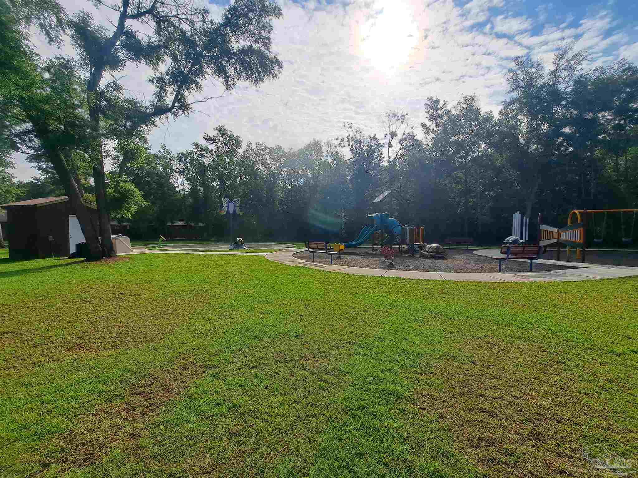 5351 Peach Drive Pace, FL 32571 - Photo 21 of 24 a view of a swimming pool with a yard