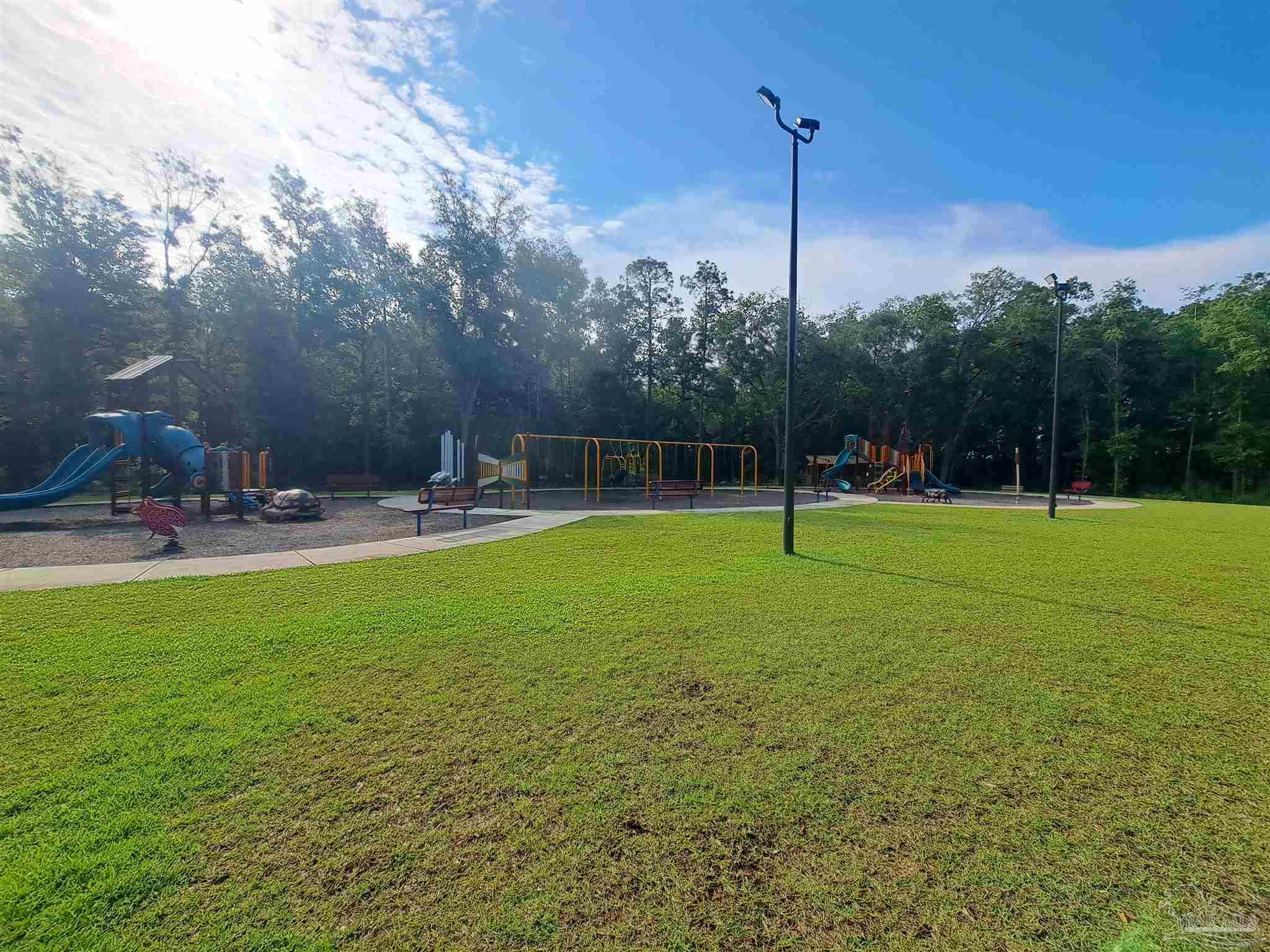 5351 Peach Drive Pace, FL 32571 - Photo 22 of 24 a view of a park with swings