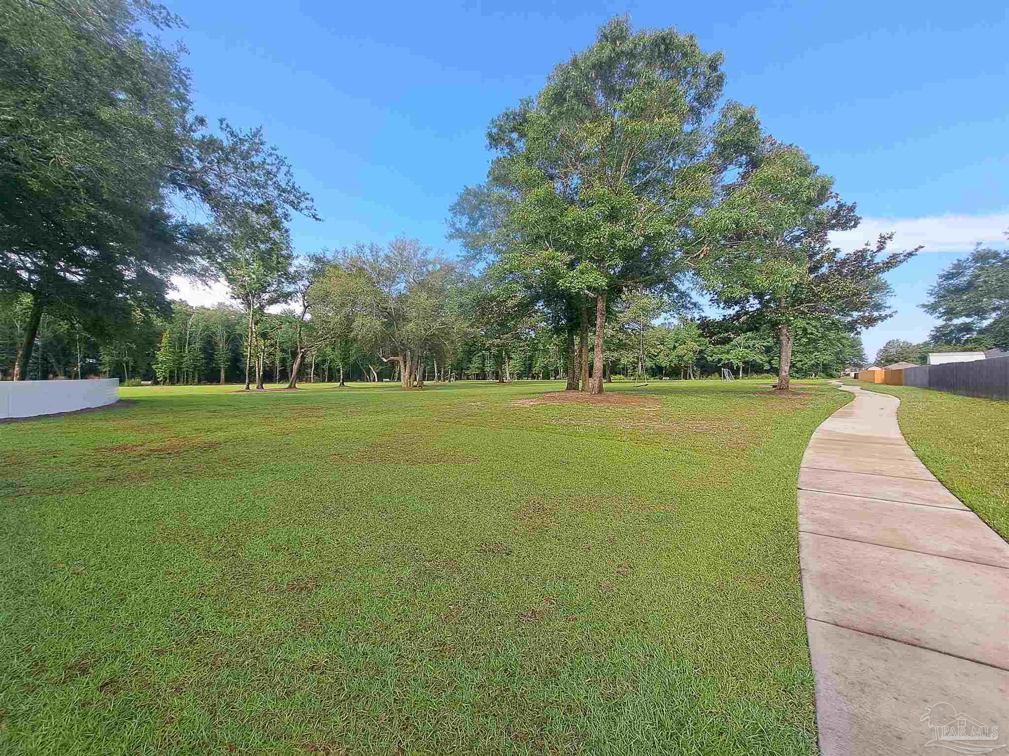 5351 Peach Drive Pace, FL 32571 - Photo 23 of 24 a view of a field with trees in the background