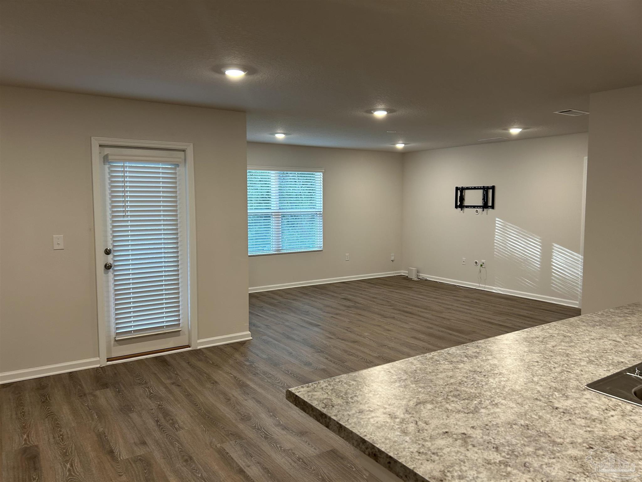 5351 Peach Drive Pace, FL 32571 - Photo 3 of 24 an empty room with wooden floor and windows