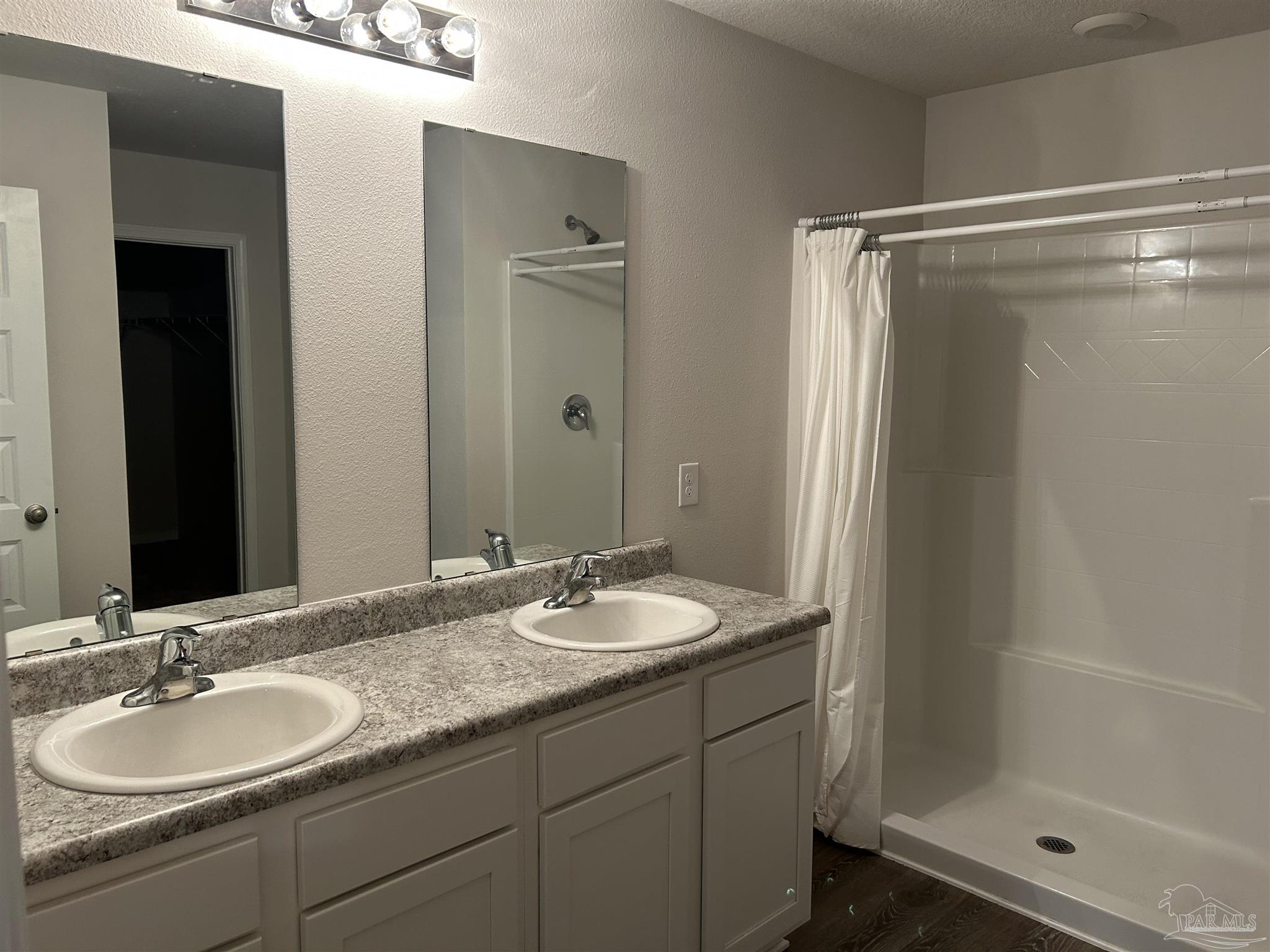 5351 Peach Drive Pace, FL 32571 - Photo 10 of 24 a bathroom with a granite countertop sink shower and a mirror