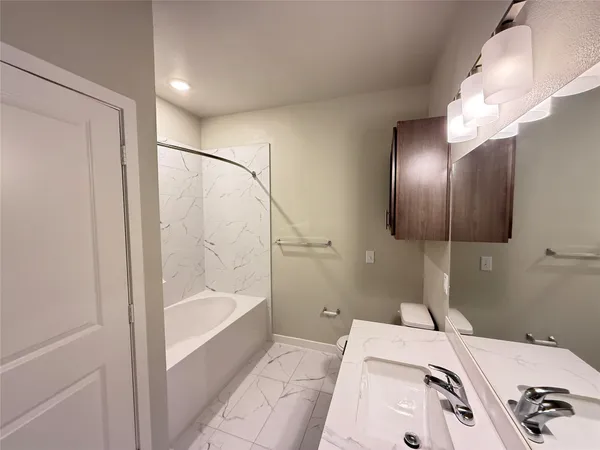 a bathroom with a bathtub and a shower