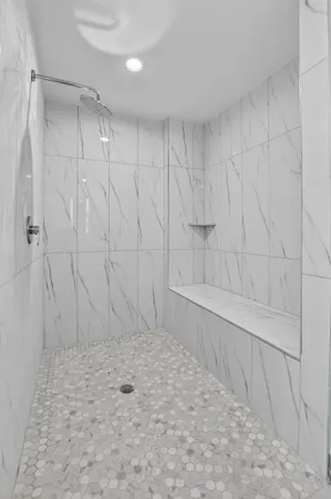 a view of a hallway with closet and a living room