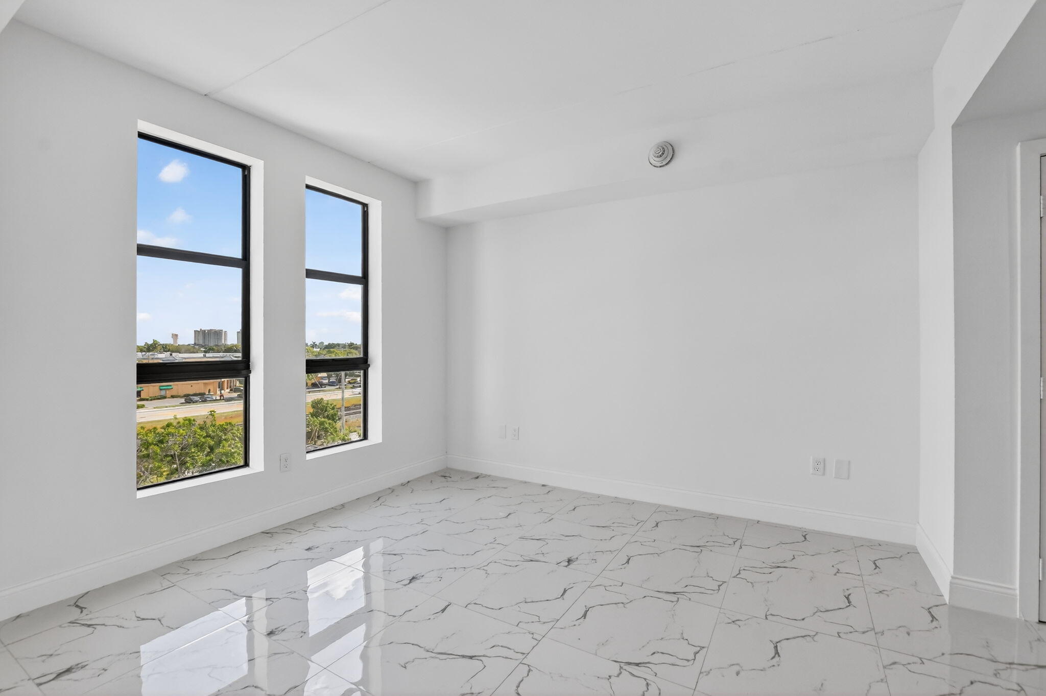350 West Hidden Valley Boulevard, Unit 201 Boca Raton, FL 33487 - Photo 15 of 33 an empty room with windows