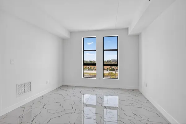 a bathroom with a granite countertop toilet sink and mirror