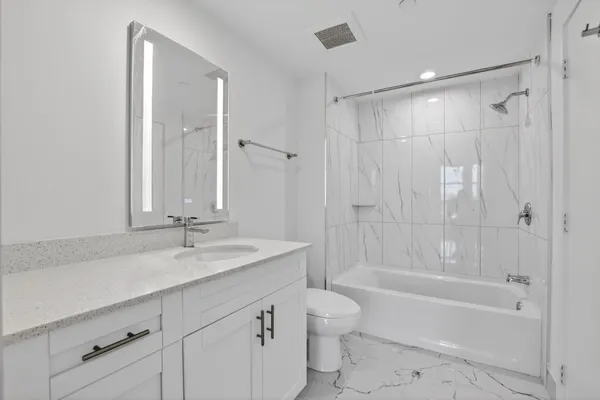 a kitchen with stainless steel appliances granite countertop a refrigerator sink and stove