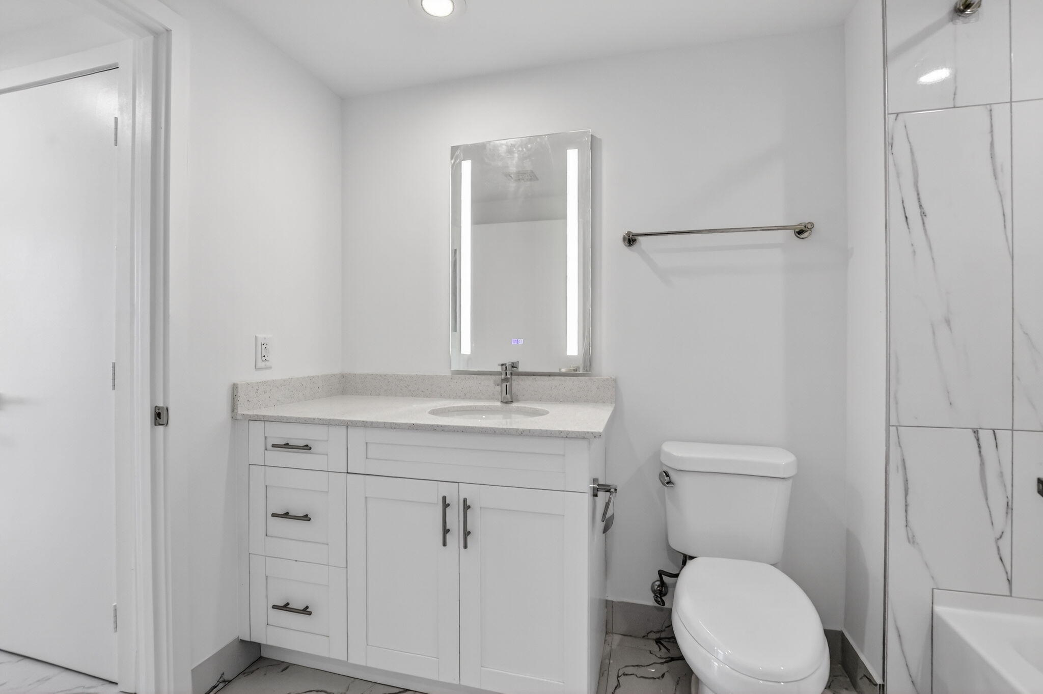 350 West Hidden Valley Boulevard, Unit 201 Boca Raton, FL 33487 - Photo 23 of 33 a bathroom with a granite countertop toilet sink and mirror