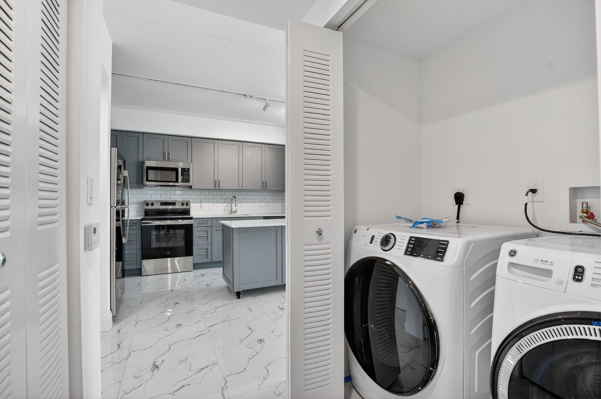 350 West Hidden Valley Boulevard, Unit 201 Boca Raton, FL 33487 - Photo 24 of 33 a view of a kitchen with washer and dryer