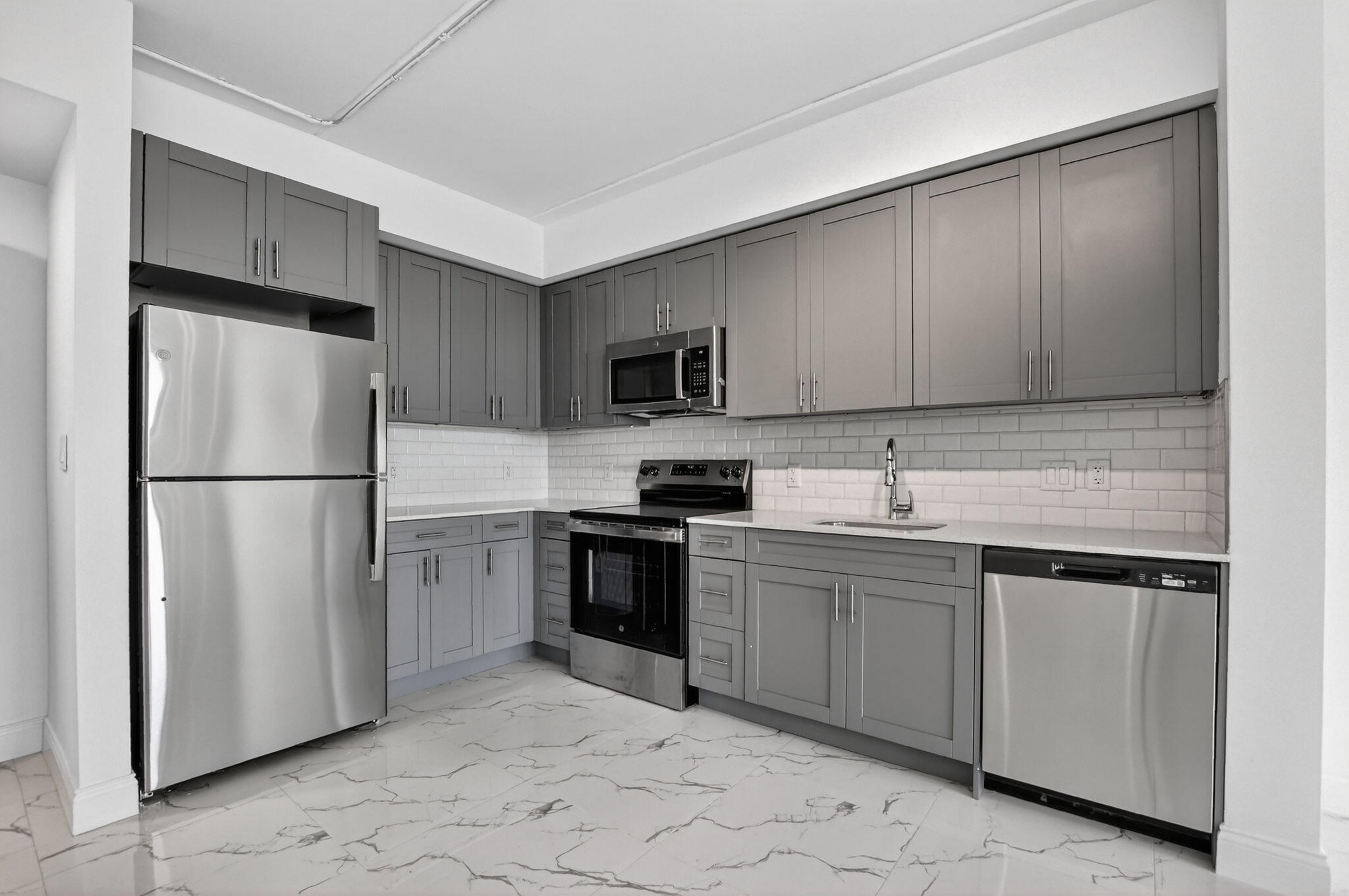 350 West Hidden Valley Boulevard, Unit 201 Boca Raton, FL 33487 - Photo 25 of 33 a kitchen with stainless steel appliances granite countertop a refrigerator sink and stove