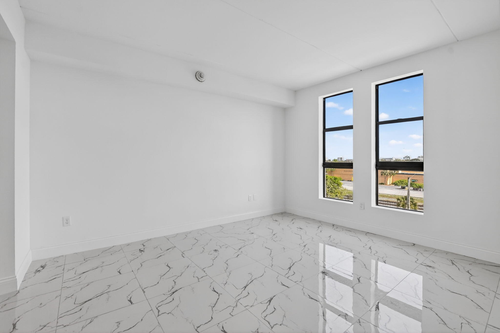 350 West Hidden Valley Boulevard, Unit 201 Boca Raton, FL 33487 - Photo 9 of 33 an empty room with windows and closet