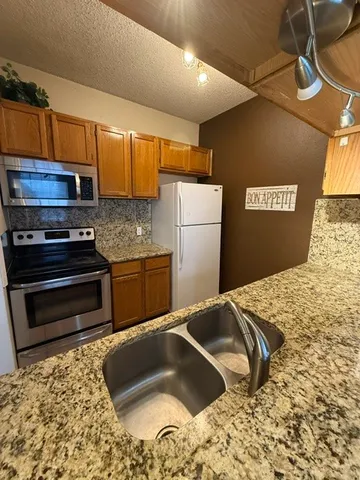 a kitchen with a sink and a refrigerator