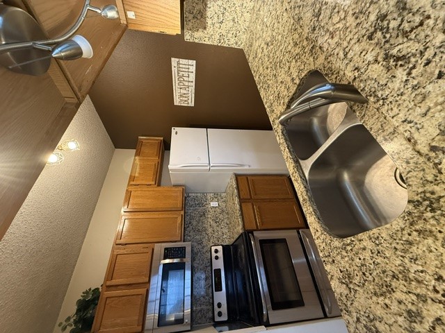 2300 Leon Street, Unit 202 Austin, TX 78705 - Photo 1 of 19 a kitchen with a sink and a refrigerator