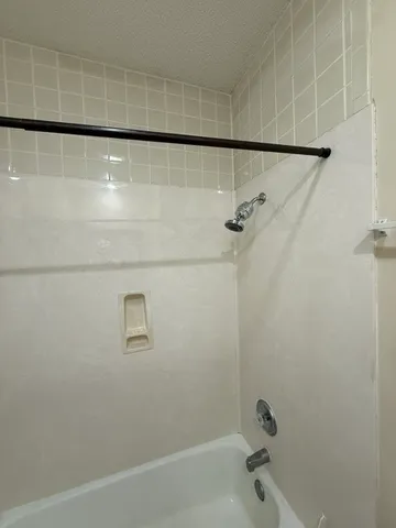 a bathroom with a shower and a bathtub