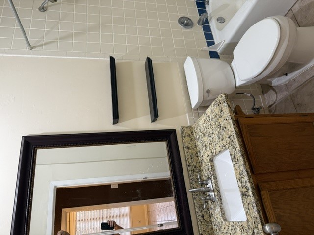 2300 Leon Street, Unit 202 Austin, TX 78705 - Photo 16 of 19 a bathroom with a granite countertop toilet sink and mirror