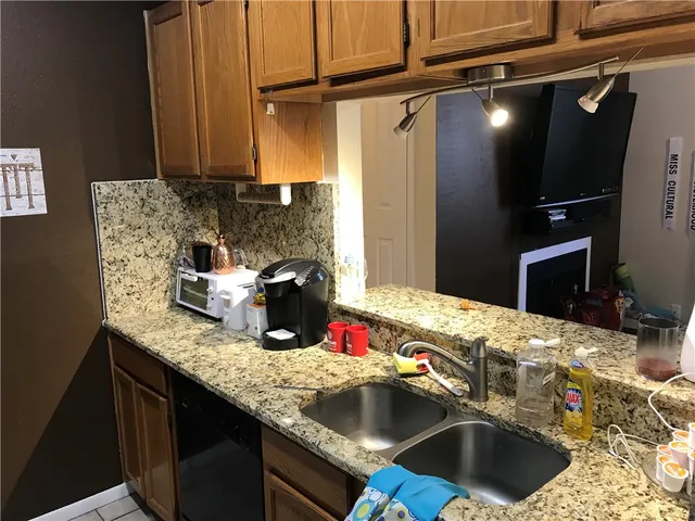 a kitchen with a sink and a refrigerator