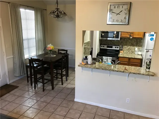 a dining room with furniture and window