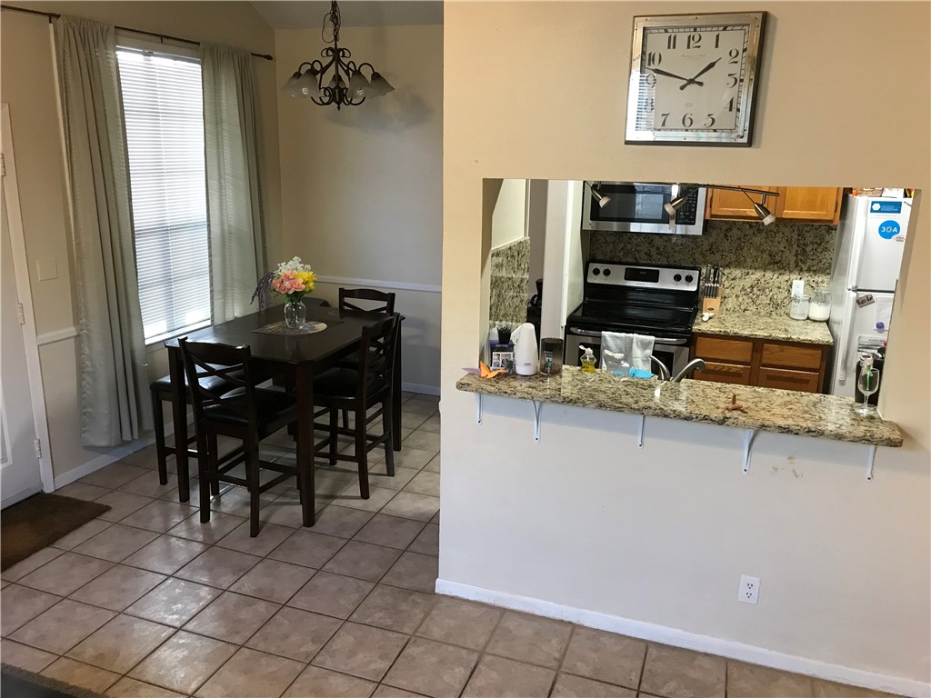 2300 Leon Street, Unit 202 Austin, TX 78705 - Photo 3 of 19 a dining room with furniture and window