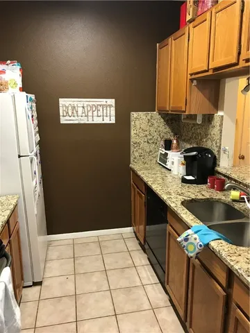 a kitchen with a sink stove and refrigerator