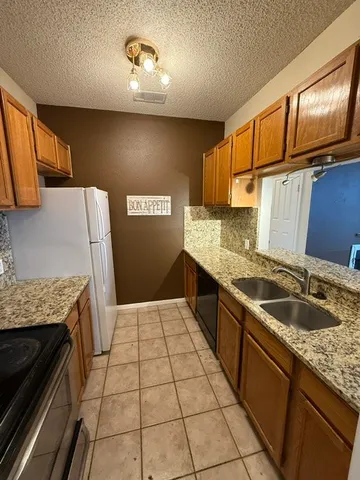 a kitchen with a sink stove and cabinets